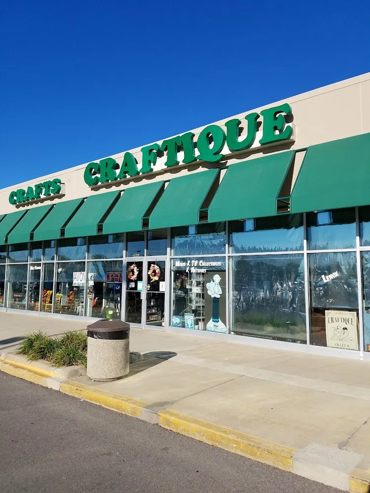 Craftique storefront with green awnings in Garden City