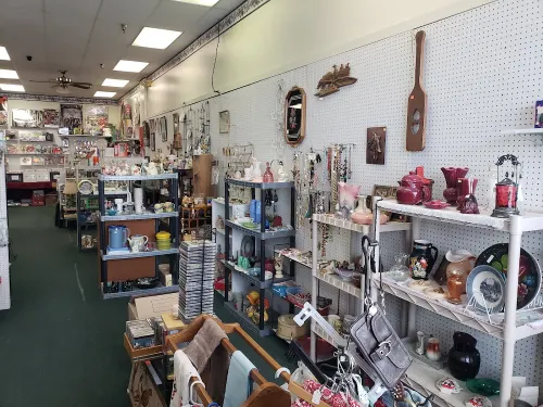 Shelves of vintage kitchenware, jewelry, records, and decor